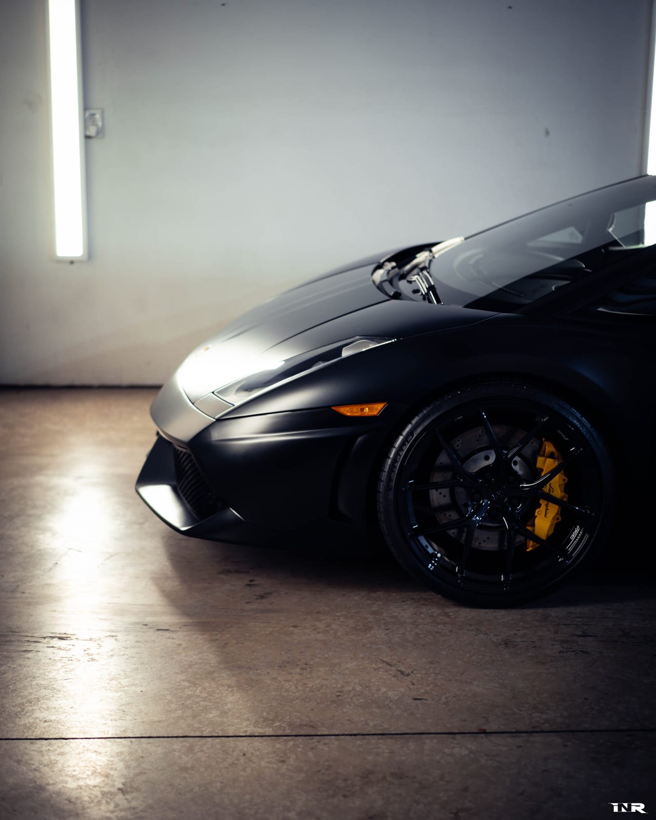 Front three-quarter in the shop under a strip light