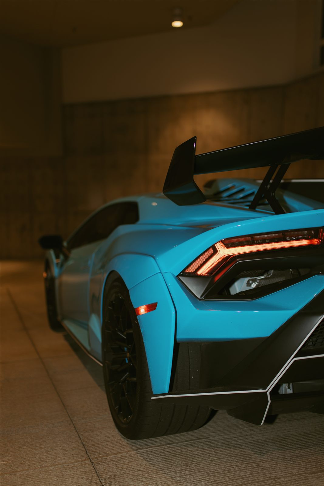 Huracán STO rear three-quarter, taillight lit under the wing