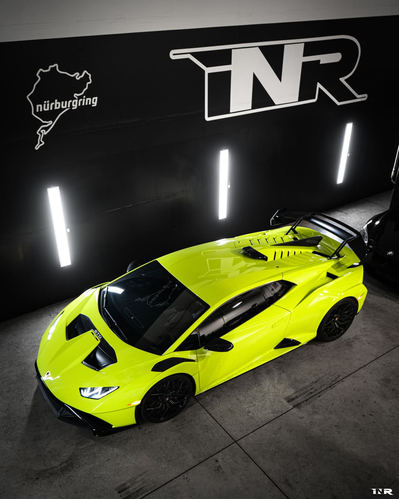 Green Huracán STO from above in the INR shop, Nürburgring outline on the wall
