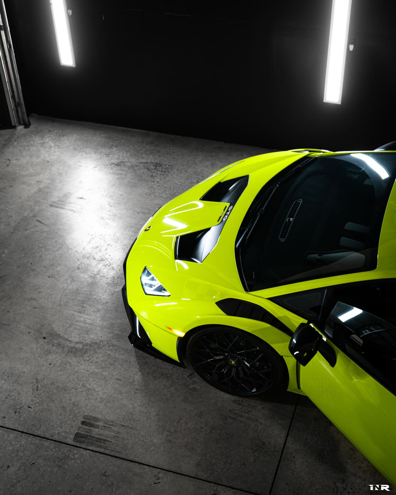 High angle over the green STO's front quarter and open door